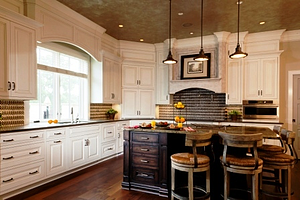 Custom painted kitchen cabinetry with stained island kitchen cabinets