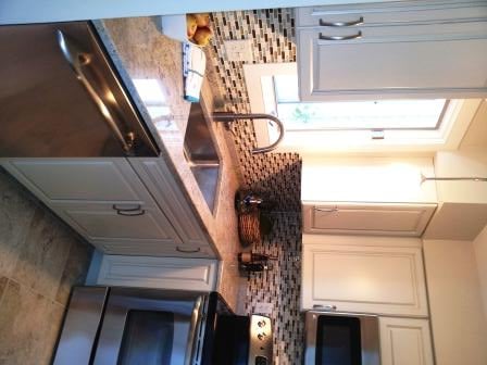 Cream painted cabinets with brown glaze.