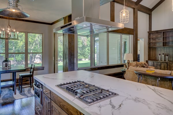 mission style kitchen with rustic lodge style lighting and modern appliances