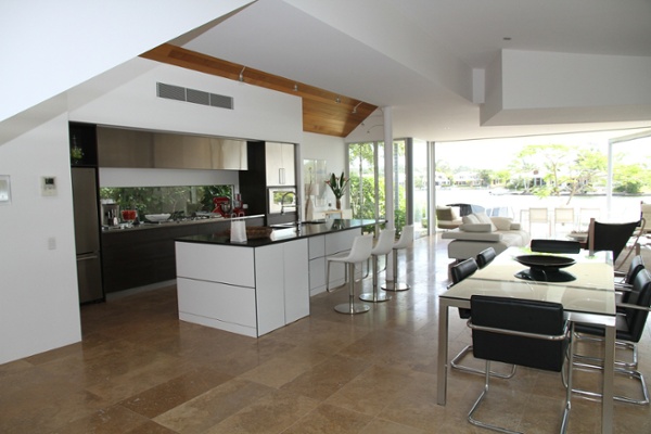 modern kitchen with white laminate cabinetry and black granite counter tops